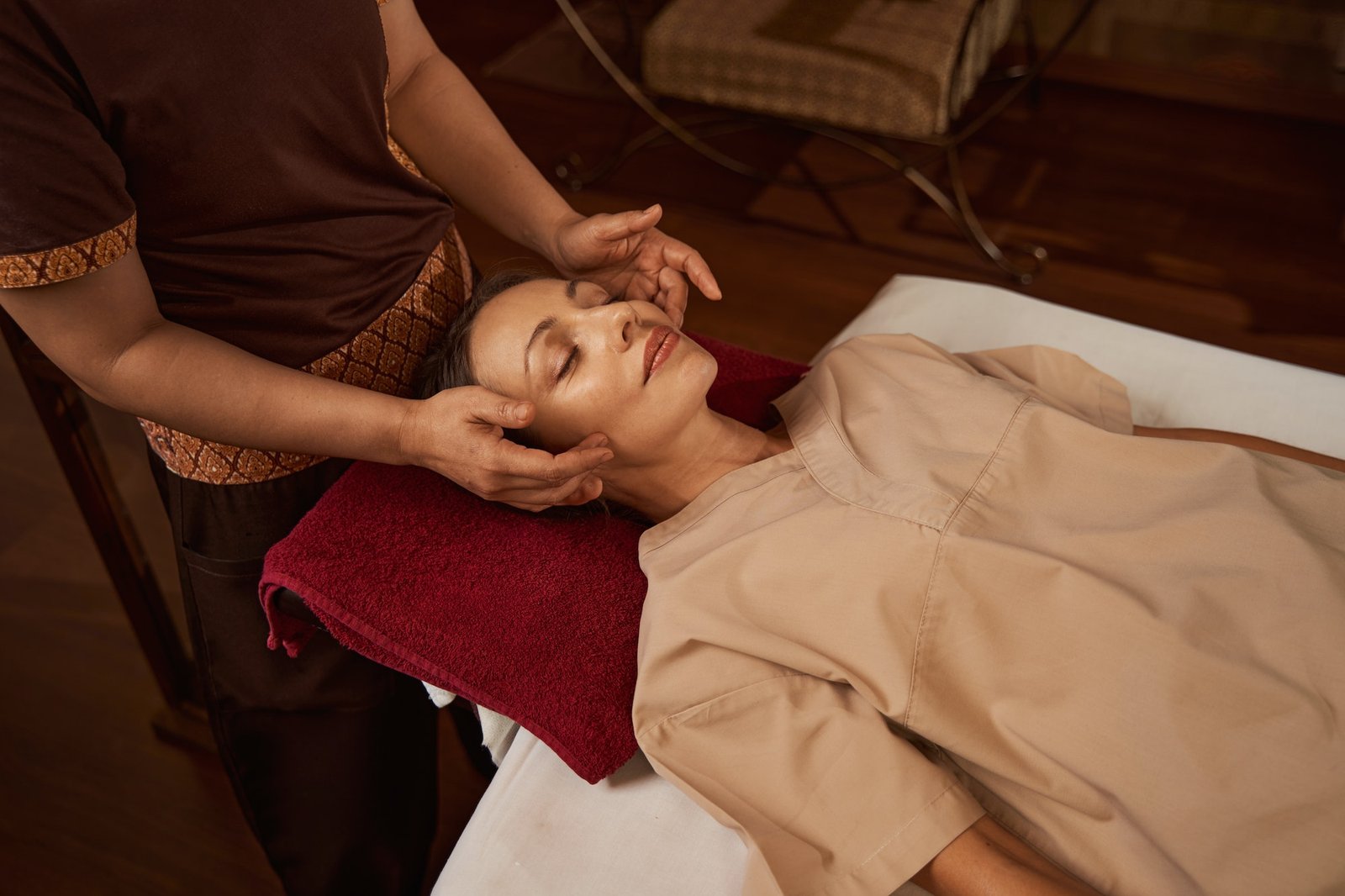 professional masseuse massaging acupressure points on client face.jpg